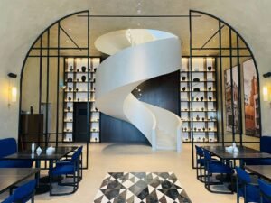 Custom fabricated stainless steel spiral staircase installed in a luxury commercial project in Riyadh by ROUNUQ